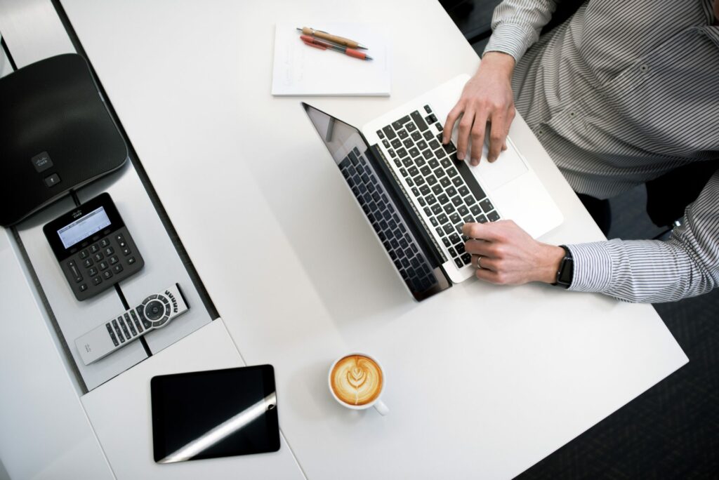 Man at desk on laptop wearing button down