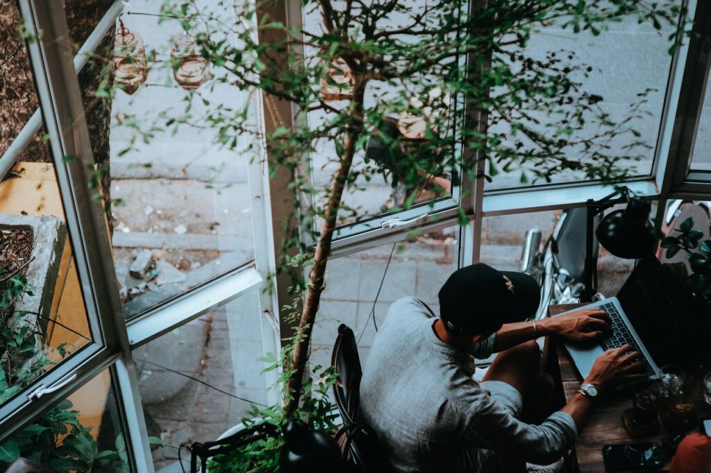 man working at an outdoor café