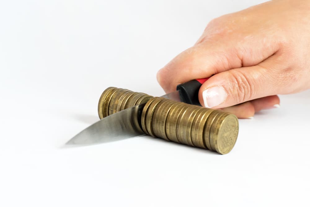 A knife separating some coins