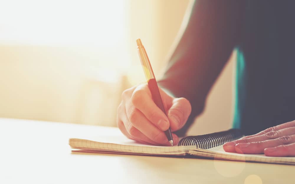 Woman writing on a notebook