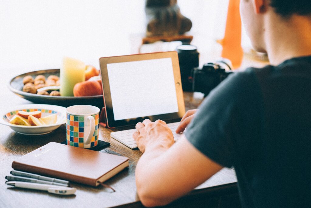 man using ipad for screenwriting job