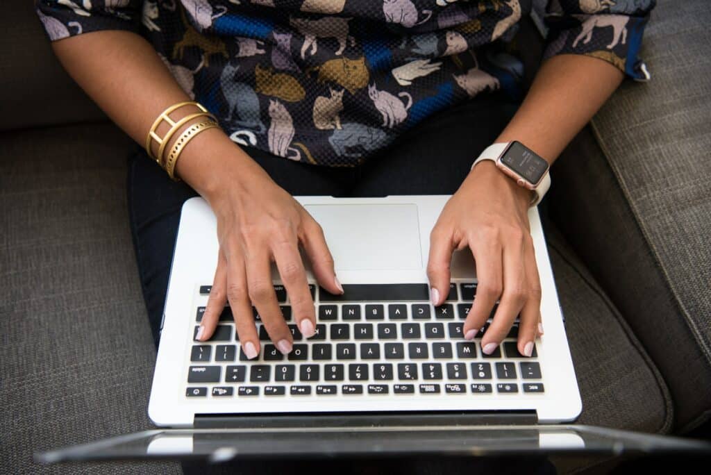 man wearing floral shirt working on a MacBook