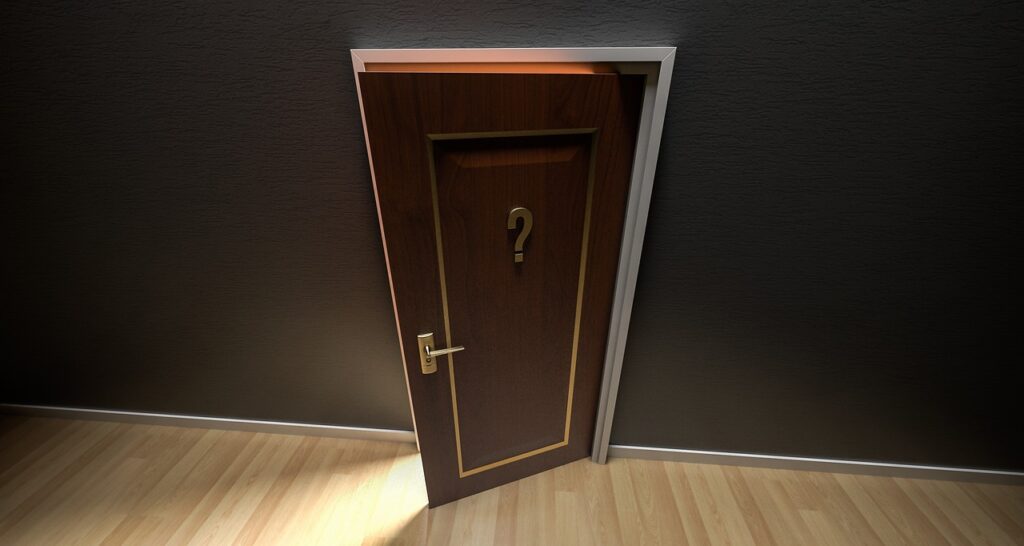 Open brown door with question mark