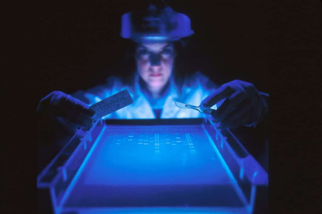 woman doing medical research in a blue lab